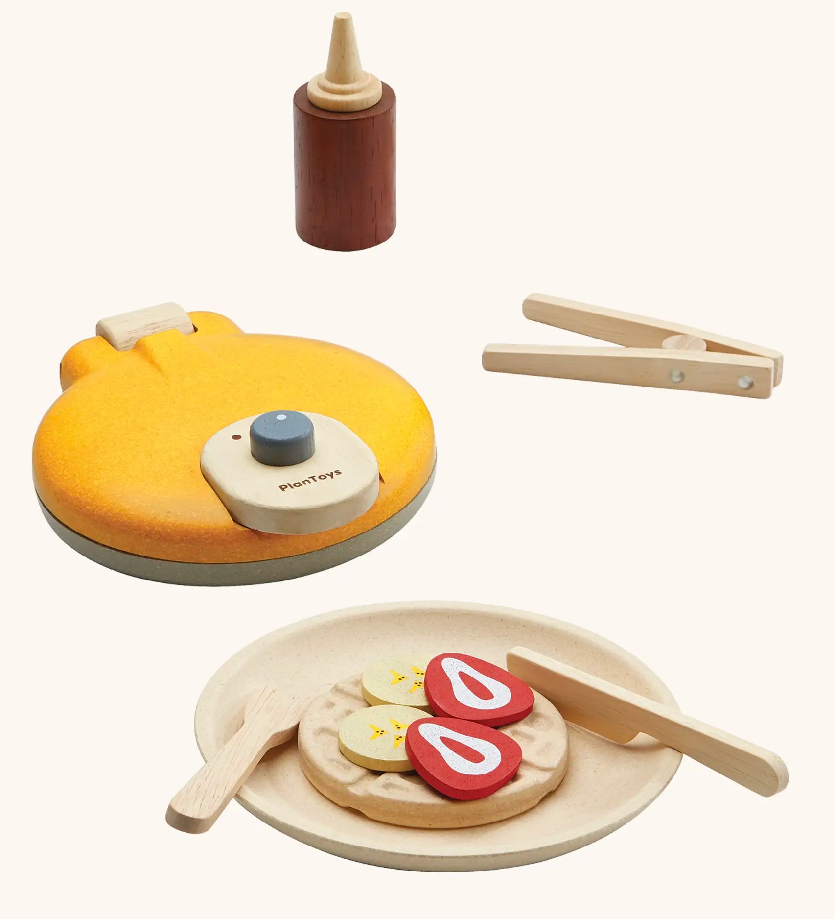 PlanToys wooden waffle play set. Includes a maker, sauce, cutlery and play food pieces