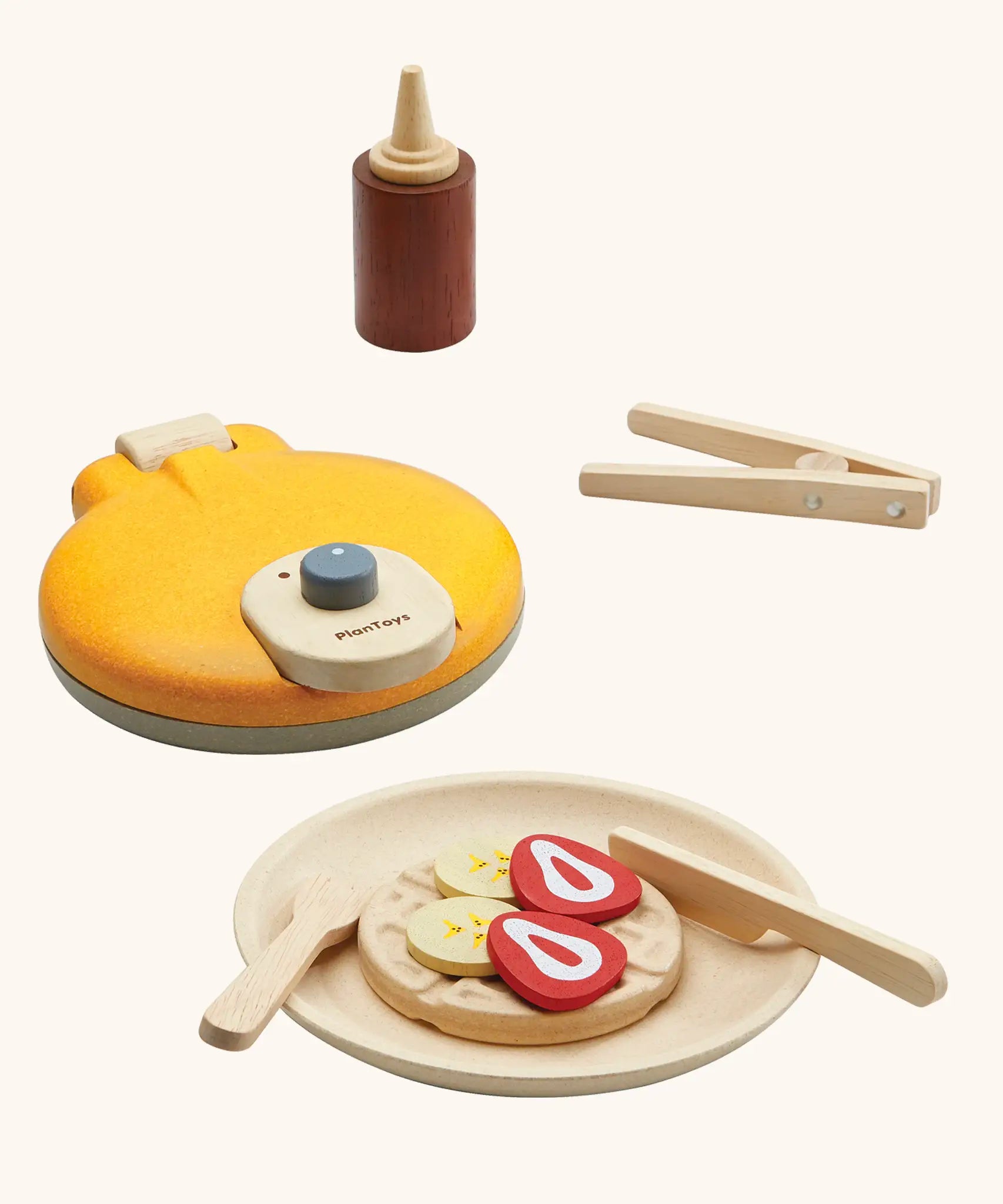 PlanToys wooden waffle play set. Includes a maker, sauce, cutlery and play food pieces