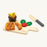 Plan Toys wooden steak set available at Babipur. Set includes a steak to cut, tomato, chips with a pot, a knife and a cutting board