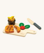 Plan Toys wooden steak set available at Babipur. Set includes a steak to cut, tomato, chips with a pot, a knife and a cutting board