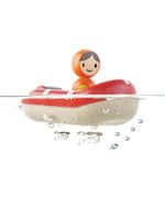 The PlanToys Coast Guard Boat Bath Toy floating on water on a white background