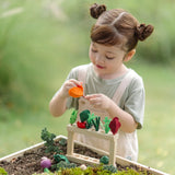 Child sorting different pieces on the PlanToys stack and sprout set on a large planter