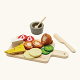 PlanToys wooden cheese and charcuterie board with play food and cutlery 