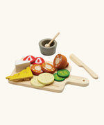 PlanToys wooden cheese and charcuterie board with play food and cutlery 