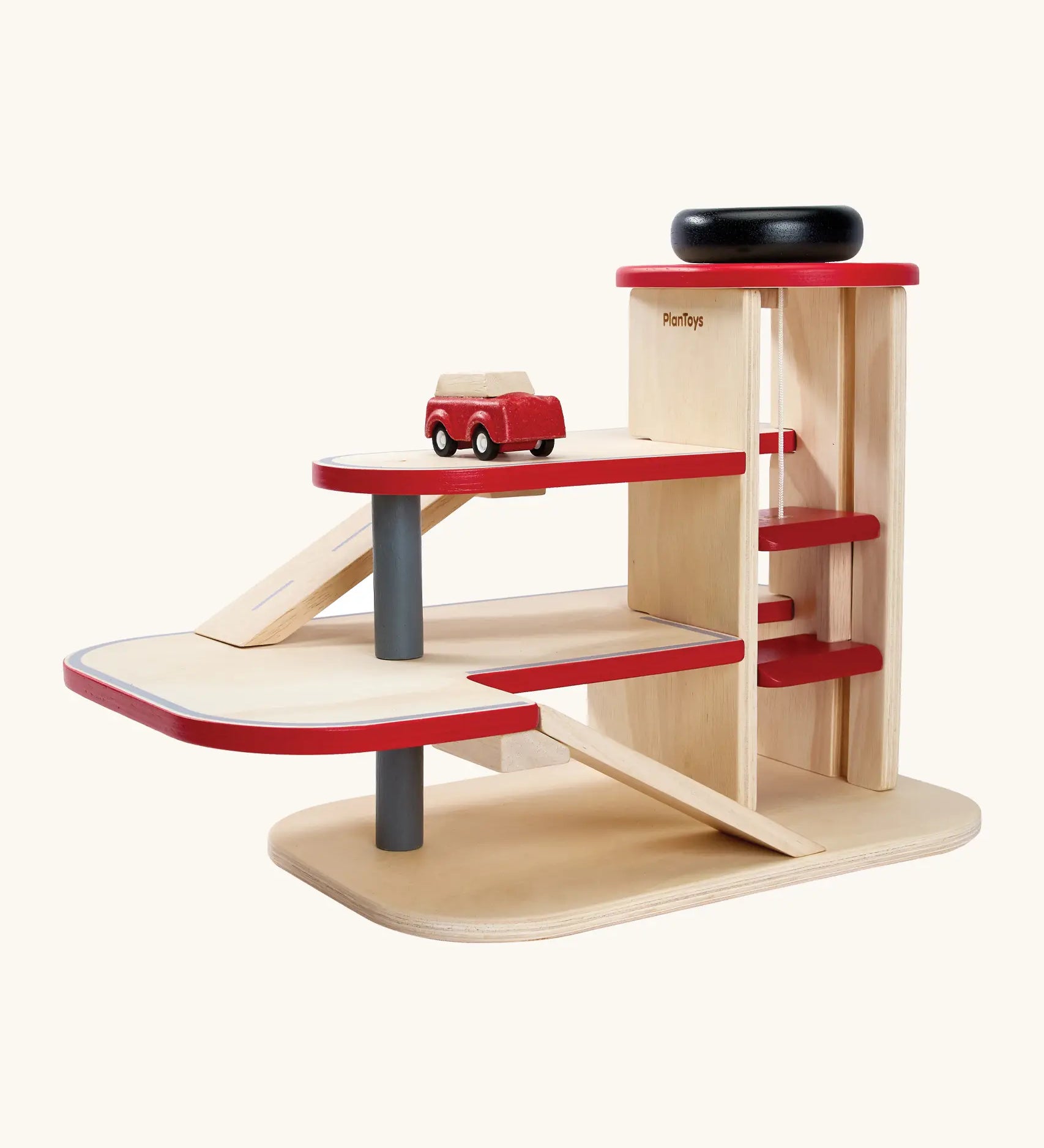 PlanToys wooden city parking garage. Features 3 levels with ramps, a wind up working lift and a vehicle