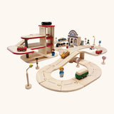 PlanToys city transit with rail and road playset. Includes wooden road and rail pieces, train station, vehicles and a carpark