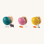 PlanToys Eggs are a fun, plastic-free, Easter egg alternative for little ones. Each egg comes with a little animal figure inside. These are a blue egg with a dog and bone, a pink egg with a rabbit and carrot, and a yellow ess with a cat and a fish. The image is on a cream background
