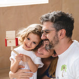 Child holding a seflie stick with a camera from the PlanToys vlogger kit taking a family selfie