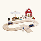PlanToys wooden roadway with vehicles and a market and farm set standing behind