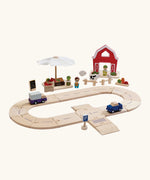 PlanToys wooden roadway with vehicles and a market and farm set standing behind