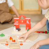 Child assembling loose wooden road pieces from the PlanToys fire & rescue roadway set.