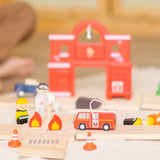 PlanToys fire & rescue roadway set showing a close up of a fire engine, emergency people figures and a fire station in the background