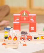 PlanToys fire & rescue roadway set showing a close up of a fire engine, emergency people figures and a fire station in the background