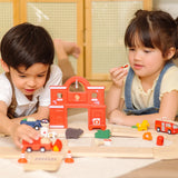 Children playing with the PlanToys fire & rescue roadway set