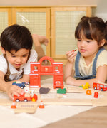Children playing with the PlanToys fire & rescue roadway set