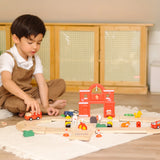 Child playing with the fire engine on the road from the PlanToys fire & rescue roadway set 