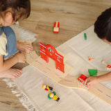Overhead view of children playing with the PlanToys fire & rescue roadway set. 