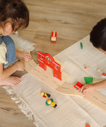 Overhead view of children playing with the PlanToys fire & rescue roadway set. 
