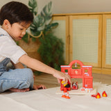 Child playing with the PlanToys fireman figure and fire station set