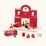 PlanToys wooden fire station set showing a fireman figure, fire engine and other items