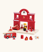 PlanToys wooden fire station set showing a fireman figure, fire engine and other items