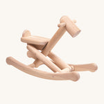 PlanToys Foldable Rocking Horse, made from wood with the beautiful wood grain showing on each piece. On a cream background