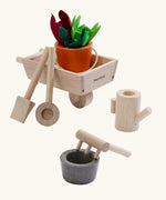 PlanToys wooden wheelbarrow set with garden tools and a bucket with loose veg