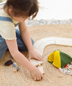 Children holding loose road pieces from the PlanToys wooden jungle explorers road playset 