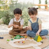 Children playing with the PlanToys wooden jungle explorers road playset 