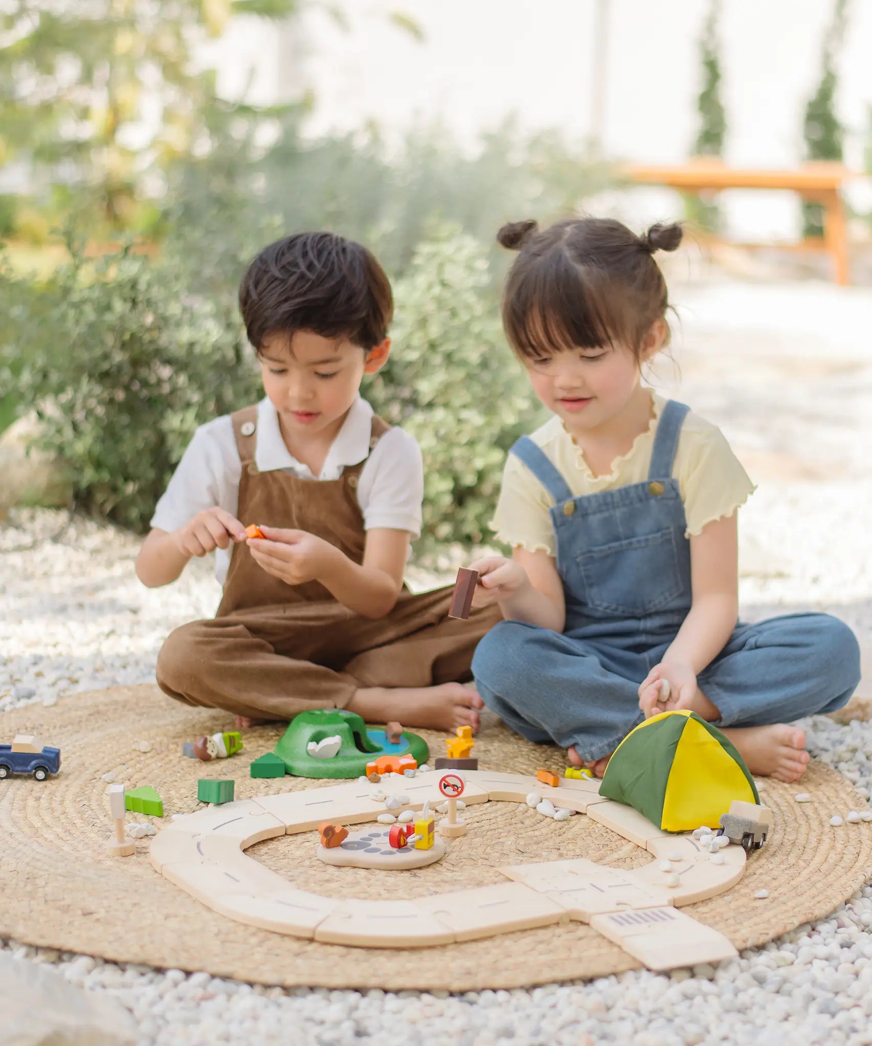 Children playing with the PlanToys wooden jungle explorers road playset 