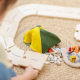 Children assembling road pieces from the PlanToys wooden jungle explorers road playset