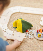 Children assembling road pieces from the PlanToys wooden jungle explorers road playset