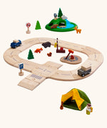 PlanToys play setup using wooden road pieces with cars, a tent and a grassy mount with wooden animal figures