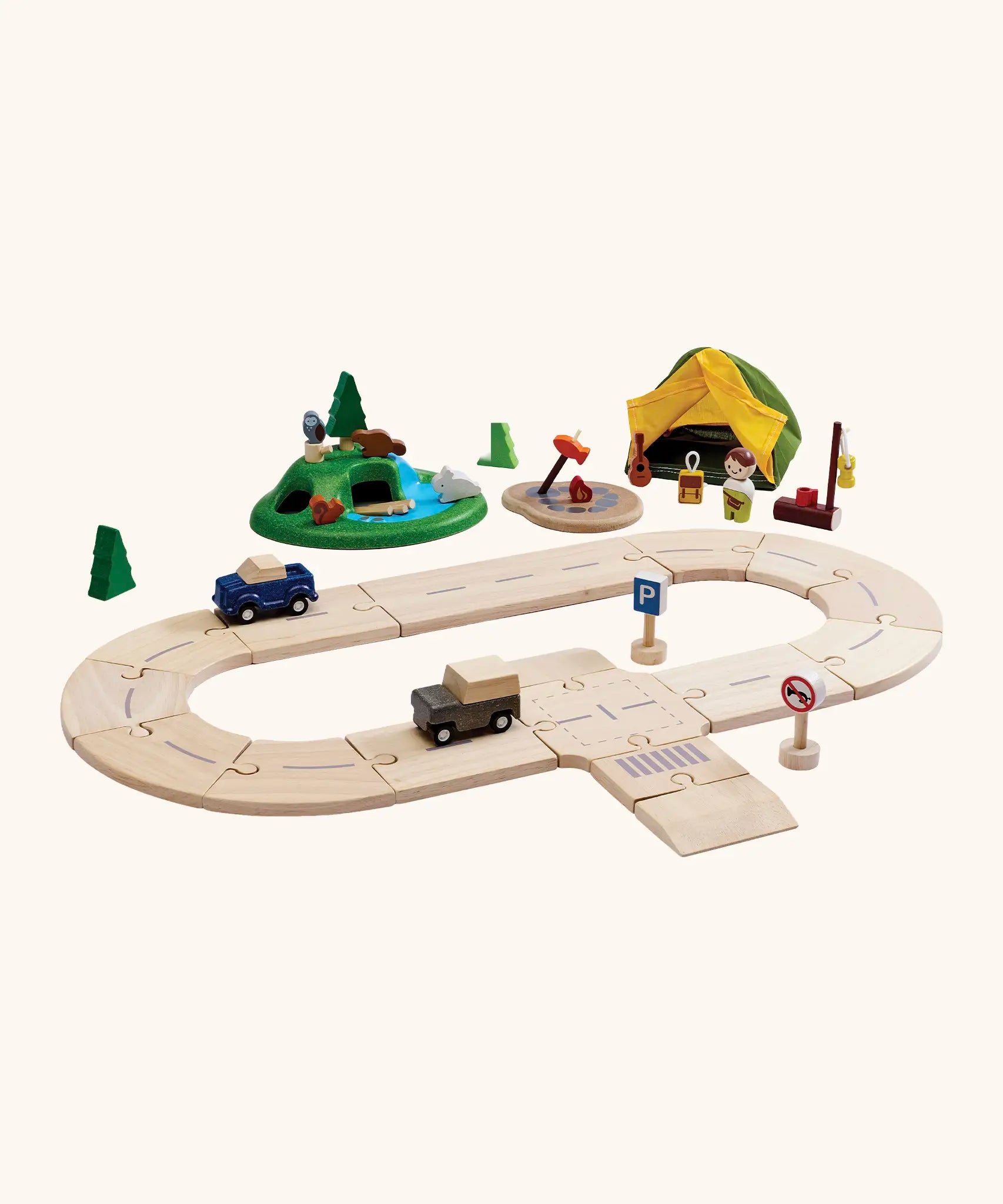PlanToys play setup showing wooden road pieces with cars, a tent and a grassy mount with wooden animal figures