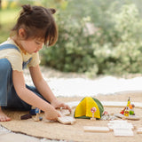 Children assembling loose road pieces from the the PlanToys wooden jungle explorers road playset 