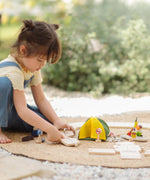 Children assembling loose road pieces from the the PlanToys wooden jungle explorers road playset 
