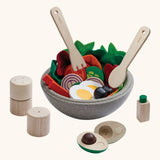 PlanToys wooden little chef's salad set. showing playfood inside a bowl and cutlery hovering above 