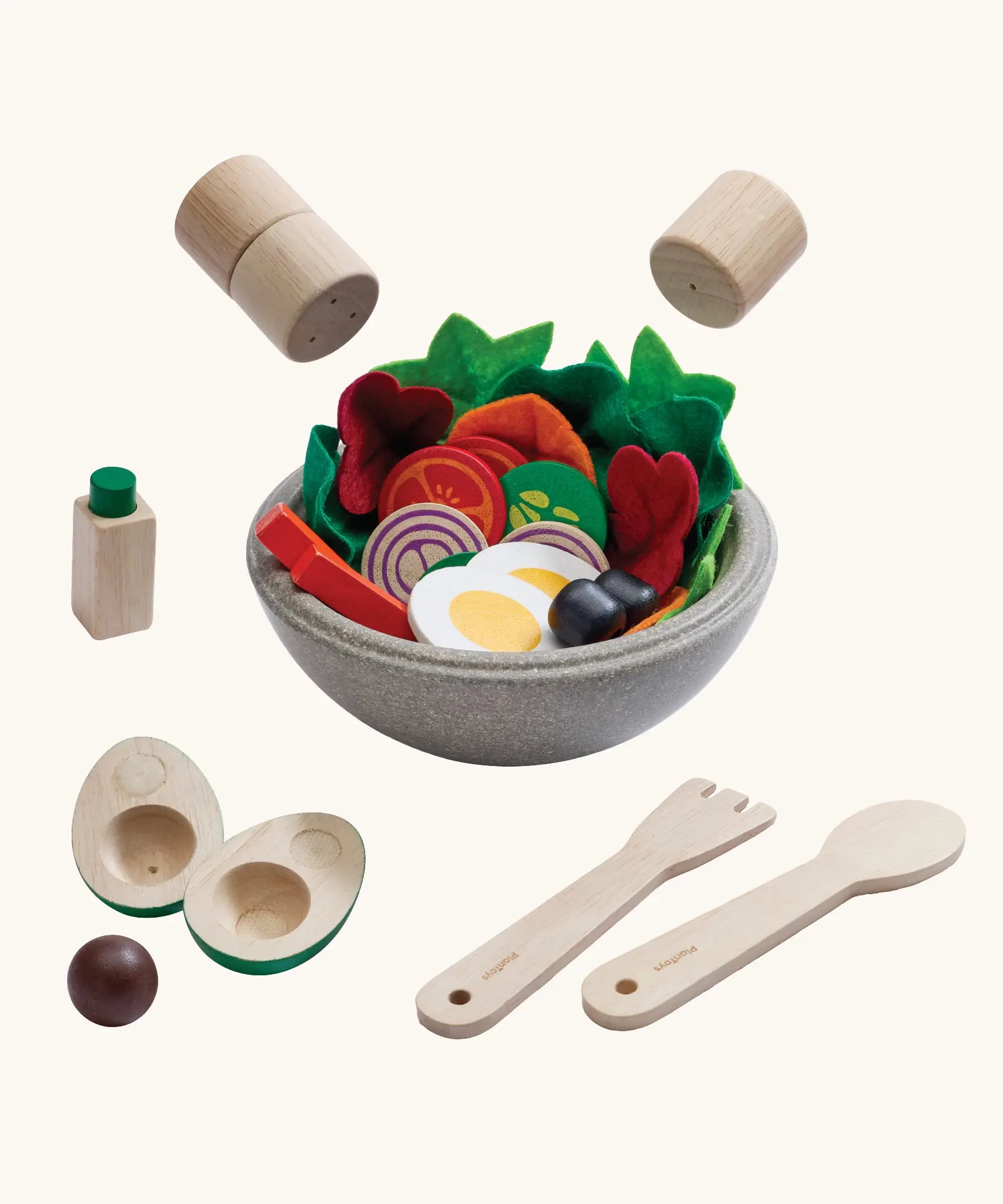 PlanToys little chef's salad set showing  bowl full of wooden playfood standing next to cutlery and salt and pepper shakers hovering above