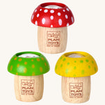 The PlanToys Mushroom Kaleidoscopes look just like a real toy mushroom, and a fun sensory experience. The one at the top is red with white spots, the bottom left is green with yellow spots, and the bottom right is yellow with green spots. The image is on a cream background.