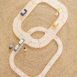 Overhead view of PlanToys rails and road pieces connected together with vehicles on top