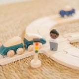 PlanToys my first rail road play set showing a close up of the train with magnetic connectors and a wooden man figure