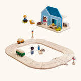 PlanToys my first roadway next to a blue home set with wooden people figures
