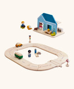 PlanToys my first roadway next to a blue home set with wooden people figures