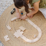 Child assembling a rail road using pieces fro the PlanToys my first train set 