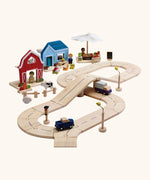 PlanToys my little neighbourhood roadway playset. Includes wooden road pieces, vehicles, market, home and a farm with small animal pieces