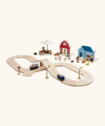 PlanToys wooden road pieces with vehicles next to a home, farm and market stall set