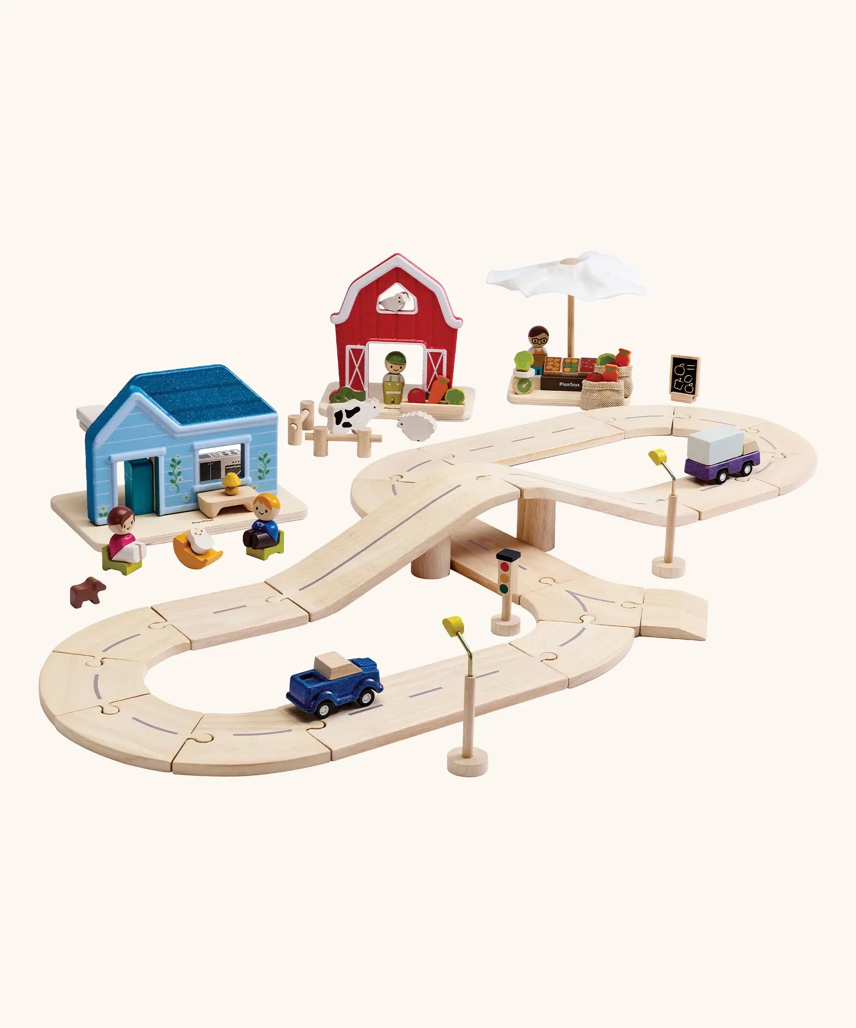PlanToys my little neighbourhood roadway playset. Showing vehicles on wooden road pieces, market, home and a farm set