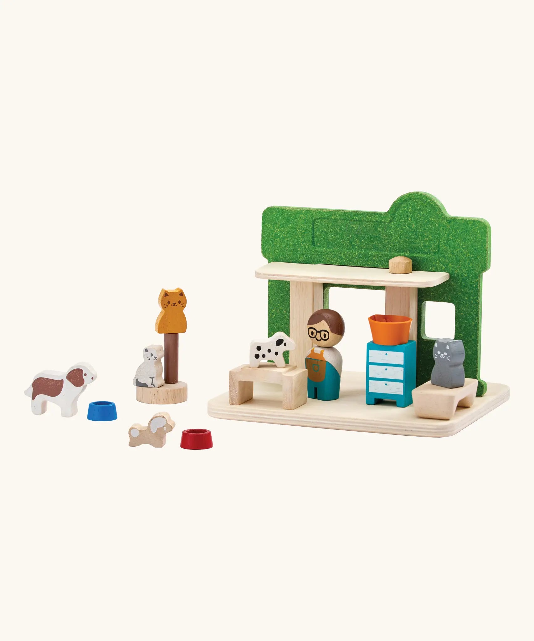 Back of the PlanToys wooden pet shop showing the different animal and shop keeper figures and other accessories 