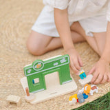 Child playing with the PlanToys pet shop play set showing the different animal figures 