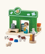 Loose animal and shop keeper  figures around the PlanToys wooden pet shop play set